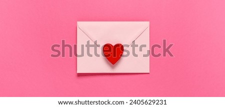 Envelope and red heart on pink background, top view. Valentine's Day celebration Royalty-Free Stock Photo #2405629231