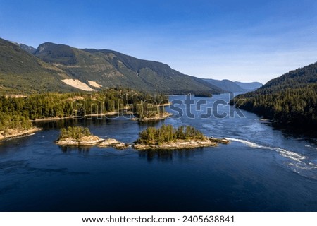 Skookumchuck Narrows with Sechelt Inlet in the Background. Sunshine Coast, British Columbia, Canada, during a pristine sunset. Aerial picture of the wild scenery. 