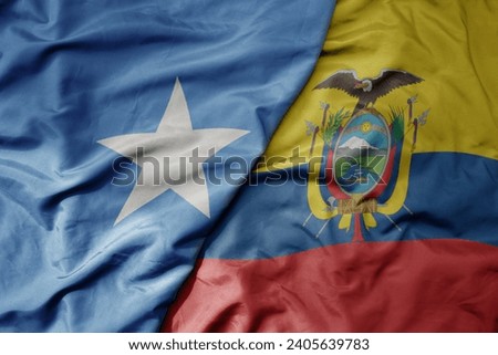 big waving national colorful flag of ecuador and national flag of somalia . macro