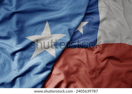 big waving national colorful flag of chile and national flag of somalia . macro