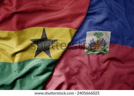 big waving national colorful flag of haiti and national flag of ghana . macro