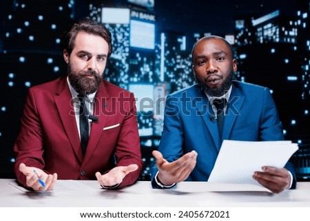 Diverse reporters covering new topics on midnight talk show, broadcasting latest events worldwide. Journalists team presenting live information from media papers, read headlines.