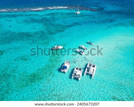 Stingray City Grand Cayman Cayman Islands in the pristine blue turquoise Caribbean sea water to the Atlanic ocean  with boats yachts  people snorkel Royalty-Free Stock Photo #2405673207