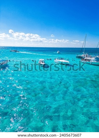 Beach day at Stingray city in Grand Cayman Rum Point sandbar Cayman Islands with boats people snorkelling white sky blue sky tropical   Royalty-Free Stock Photo #2405673607