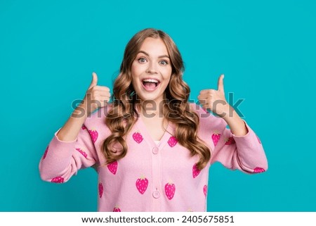 Portrait of young funky model girl excited makes like symbol two thumbs up good job makeup artist isolated on blue color background