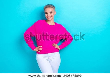 Portrait of satisfied pretty cute girl with dyed hairdo wear knit sweater arms on waist smiling isolated on turquoise color background