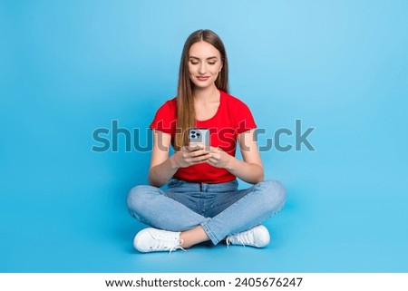 Photo of adorable cute lady wearing stylish red clothes writing comment sending sms apple iphone isolated on blue color background