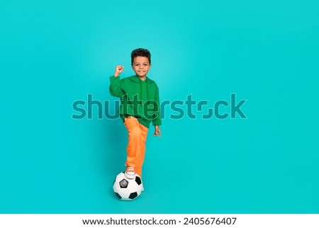 Full length photo of glad positive boy football player celebrate goal fifa championship empty space isolated on cyan color background Royalty-Free Stock Photo #2405676407