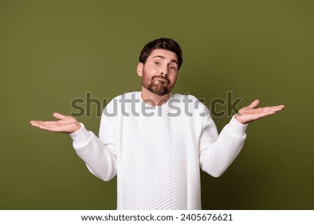 Photo of uncertain unsure man wear trendy clothes shrugging shoulders no answer isolated on khaki color background Royalty-Free Stock Photo #2405676621
