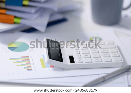 Calculator with financial documents on table office, Tax of data gathering and statistical concept.
