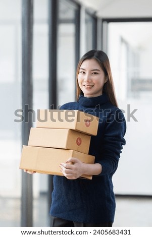 Owner business asian with boxes delivers to customers, Online shopping and small business SME concept. Royalty-Free Stock Photo #2405683431