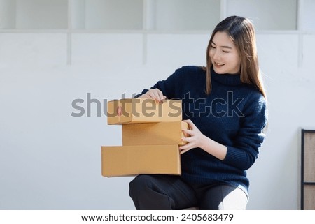 Owner business asian with boxes delivers to customers  Online shopping and small business SME concept. Royalty-Free Stock Photo #2405683479