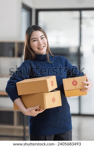 Owner business asian with boxes delivers to customers, Online shopping and small business SME concept. Royalty-Free Stock Photo #2405683493