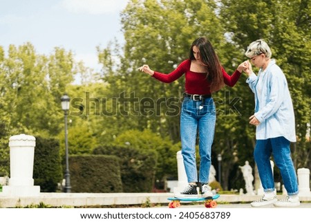 girl teaching how to skate to another girl