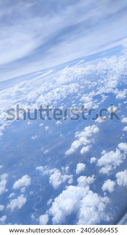 the beauty of the clouds and views of the Indonesian mainland when seen from the plane.  Royalty-Free Stock Photo #2405686455