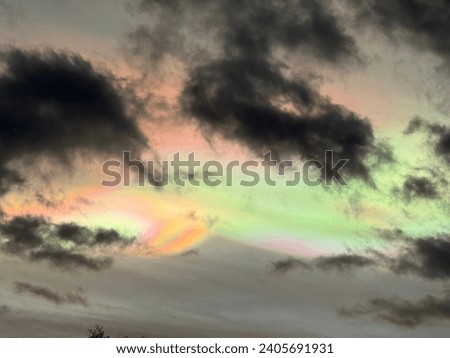 Nacreous (aka Rainbow or mother of pearl) cloud, over the UK. Royalty-Free Stock Photo #2405691931