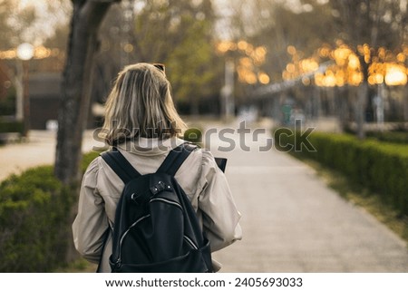 Back view portrait of a blonde student girl Royalty-Free Stock Photo #2405693033