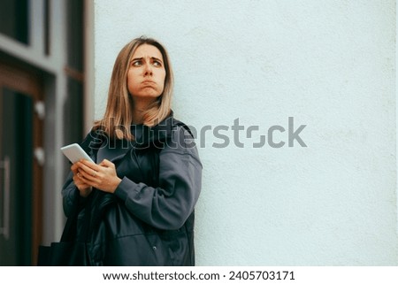 
Woman Looking Outside Checking the Weather and her Phone
Bored annoyed girl waiting for her boyfriend on a date 
