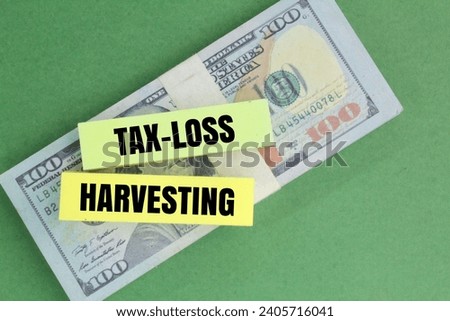 paper money and colored paper with the word TAX LOSS HARVESTING. taxation concept