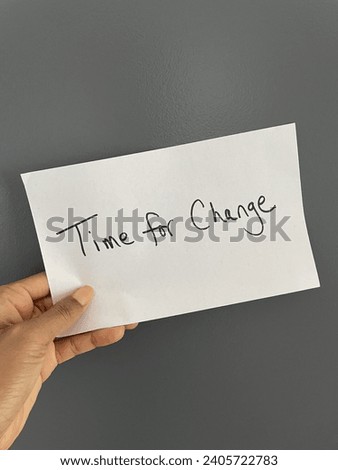 Concept image of a Black person holding a piece of paper with time for change written on it