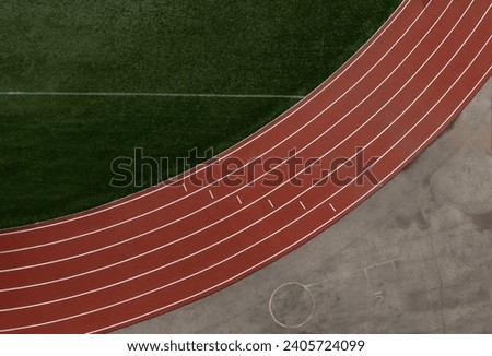 Aerial of running track and field with six lanes Royalty-Free Stock Photo #2405724099