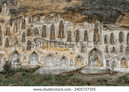 A stunning array of Buddha statues carved into the cliffside at Akauk Taung, overlooking Pyay in Myanmar, symbolizing spiritual reverence