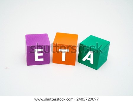 A coloured wooden block with word “ETA” on it. ETA stands for "estimated time of arrival"