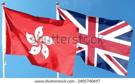 British flag and Hong Kong flag on cloudy sky. flying in the sky