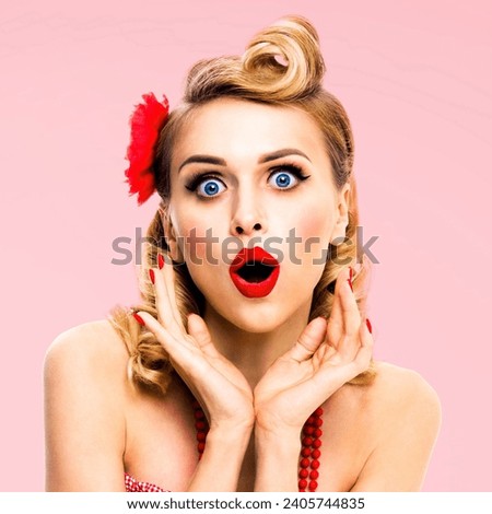 Unbelievable news! Excited surprised, very happy blondy woman. Pin up style girl with open mouth and raised hands. Retro and vintage concept. Rose pink background. Square photo