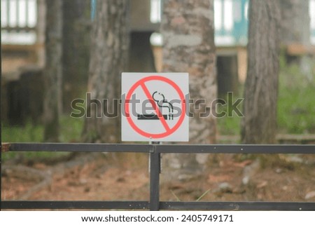 no smoking metal sign in the park.