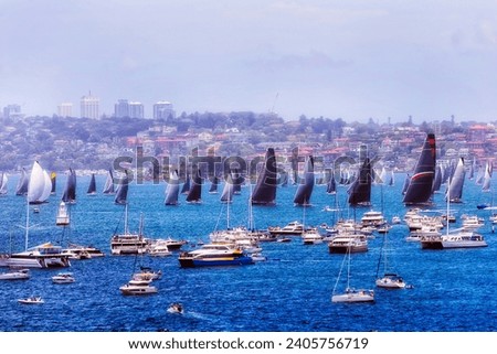 Massive flotilla of yachts boats and ships on Sydney harbour at start of Sydney Hobart Yacht race. Royalty-Free Stock Photo #2405756719
