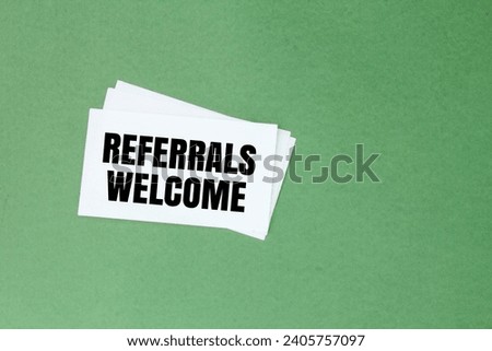 white paper with the word REFERRALS WELCOME. the concept of joining a team or a new member