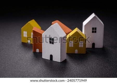 A small wooden house as an idea for investing in your own home and achieving the goal of buying real estate. Background for your idea