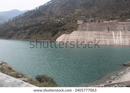 The Mangla Dam is a multipurpose dam situated on the Jhelum River in the Mirpur District of Azad Kashmir, Pakistan. Green water picture on the sea . Green water is coming into the electricity dam.