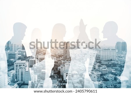 Abstract city skyline with businesspeople silhouettes on light wallpaper. Teamwork, partnership and success concept. Toned image. Double exposure
