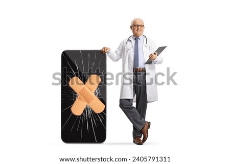 Doctor with a broken smartphone and bandage on a cracked screen isolated on white background