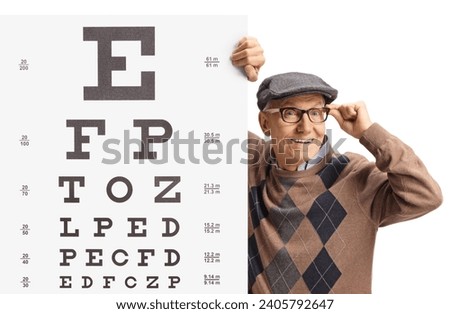 Elderly man wearing glasses and standing next to an eye exam with letters isolated on white background Royalty-Free Stock Photo #2405792647