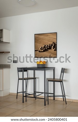 High table with chairs and fruit bowl in dining area