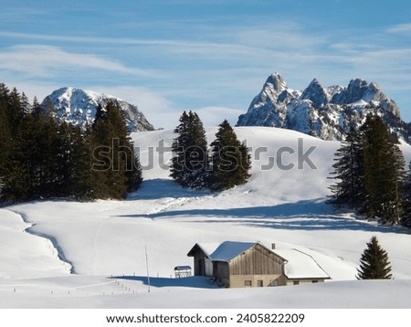 The house is high in the mountains, snow-covered Swiss incredibly beautiful mountains. Beautiful winter Swiss landscapes from the peaks.