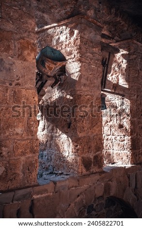 Religious architecture, ancient church bells photo. Sant Miquel del Fai is Benedictine monastery. Monastery passway set in cliffs, Catalonia. High quality picture for wallpaper, article