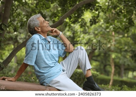 Cheerful old man feels freedom, fun and spending time at the park.