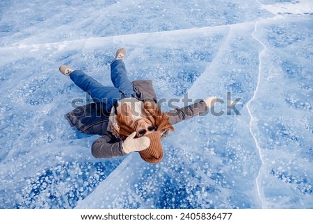 Woman background ice with gas methane bubbles lake Baikal winter.