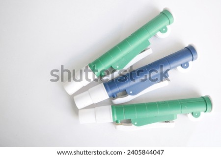 Plastic pipette filler. A device used to insert solutions or liquids into measuring pipettes in the laboratory.