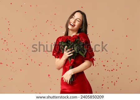 Beautiful young woman with bouquet of red roses and confetti on brown background. Valentine's Day celebration Royalty-Free Stock Photo #2405850209