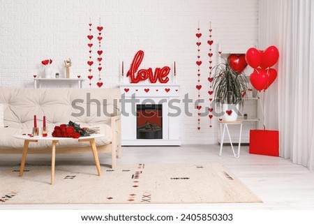 Interior of festive living room with white sofa, fireplace and decor for Valentine's Day celebration Royalty-Free Stock Photo #2405850303