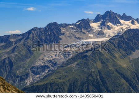 Chamonix mountain valley in the alps with the Mont Blanc Massif in the background Royalty-Free Stock Photo #2405850401