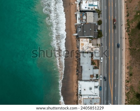 Malibu beach aerial view in California near Los Angeles, USA. Waves hitting the shore near expensive houses in Malibu. Royalty-Free Stock Photo #2405851229