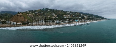 Malibu beach aerial view in California near Los Angeles, USA. Waves hitting the shore near expensive houses in Malibu. Royalty-Free Stock Photo #2405851249