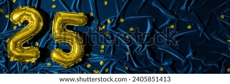 number twenty five, gold foil balloon number on blue velvet background with confetti. Birthday greeting card, inscription 25. Anniversary event. Banner. Stylish gold numeral, bright shiny shine.  Royalty-Free Stock Photo #2405851413