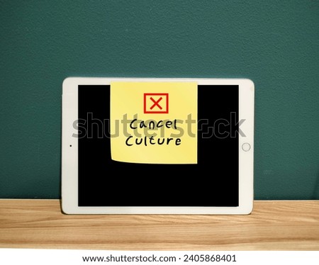 Tablet with stick note written Cancel Culture - refers to mass withdrawal or mass shamimg from public figures or celebrities who have done things that aren't socially accepted, often on social media Royalty-Free Stock Photo #2405868401
